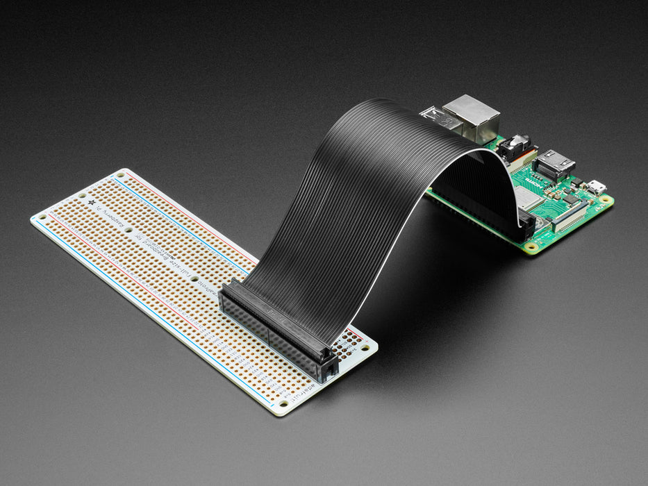 Angled shot of assembled Adafruit Perma-Proto 40-Pin Raspberry Pi Breadboard PCB with a Raspberry Pi 4.