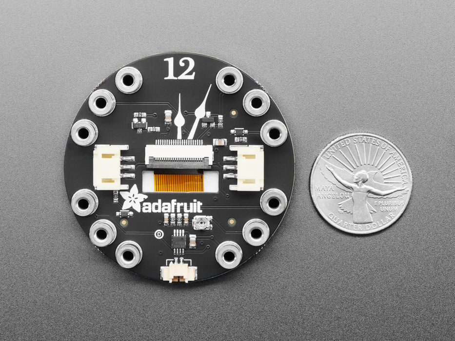 Hand pressing buttons on circuit playground, then turning over to show TFT gizmo display an image of a friendly robot or snake