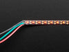 Curved NeoPixel LED strip wired to arduino, with each LED changing to a different color in the rainbow