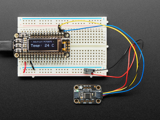 Adafruit PCT2075 Temperature Sensor with STEMMA QT / Qwiic cable plugged into a Feather showing the temperature