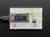  TC74A0 Breadboard Friendly I2C Temperature Sensor plugged into breadboard wired to Feather displaying the temperature