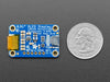 Monochrome OLED module wired to Feather showing text and circles