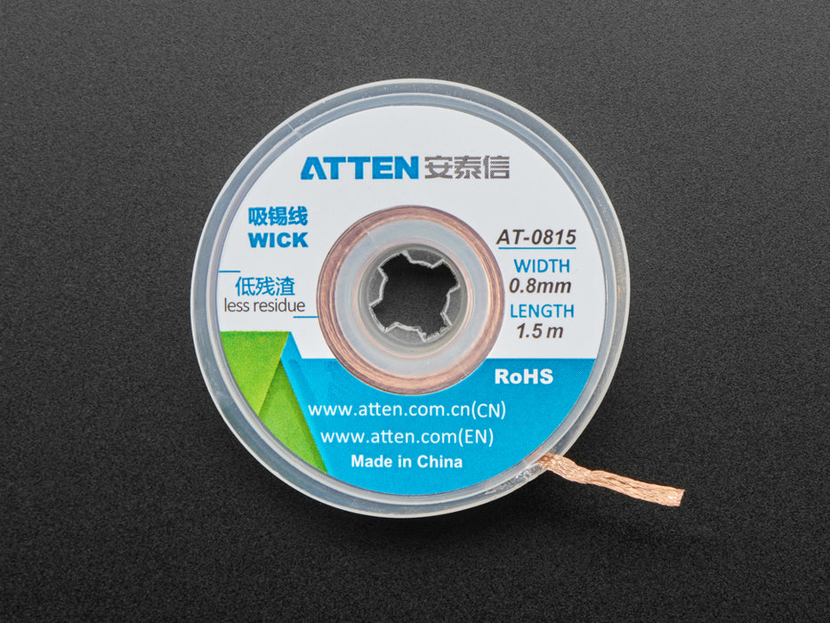 Spool of solder wick with a 0.8mm wide wick coming out.