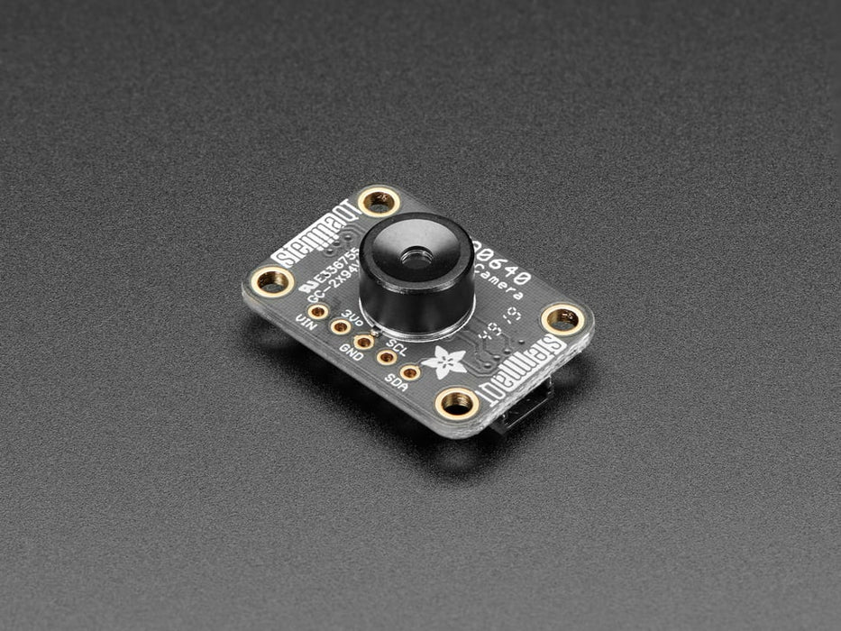 White hand holding and moving around a MLX90640 24x32 IR Thermal Camera Breakout over a Raspberry Pi. The pybadge showing a checker board image of what the camera is seeing. 