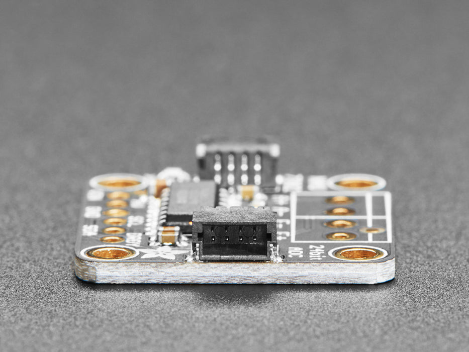 Video of a pair of white hand's trying to bend a strain gauge. The gauge is connected to a breakout board which is also connected to an OLED display on a half-size breadboard. The numbers on the OLED display show high digit numbers.