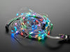 Adafruit Soft Flexible Wire NeoPixel Strand, coiled up and lit in rainbows