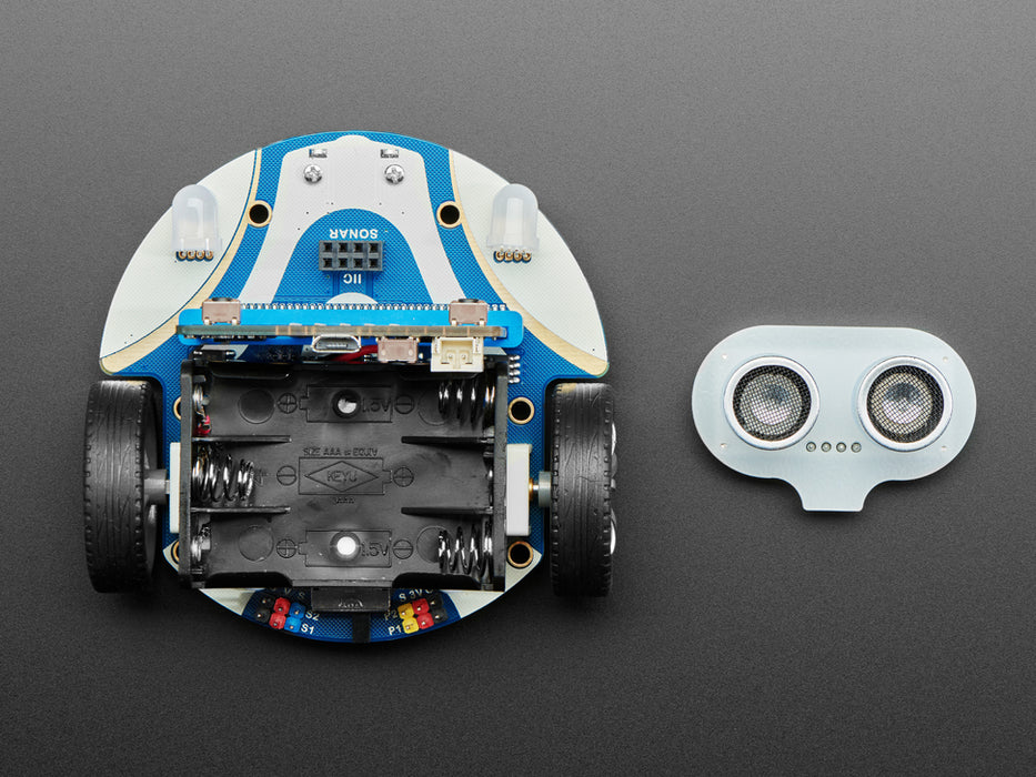 Robot driving toward human hand, then turning and avoiding it.