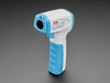 Blue and white temperature scanner standing upright on the handle