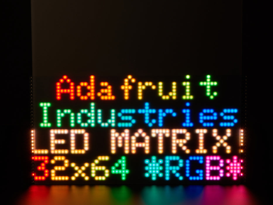 LED RGB matrix 12" x 12" with "Adafruit Industries LED Matrix" text showing, and LED acrylic slowly covering to make it nicely diffused