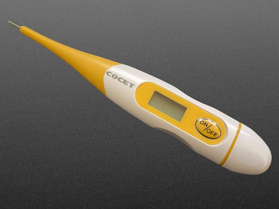 Yellow and white thermometer with an on/off button and displaying the temperature