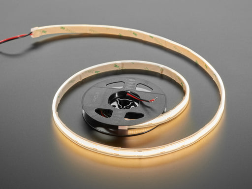 Two hands repeatedly bending and manipulating lit-up flexible warm white LED strip