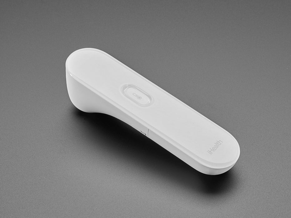 White no touch thermometer shown laying flat and displaying a temperature