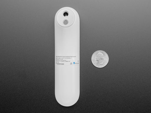 White no touch thermometer shown laying flat and displaying a temperature