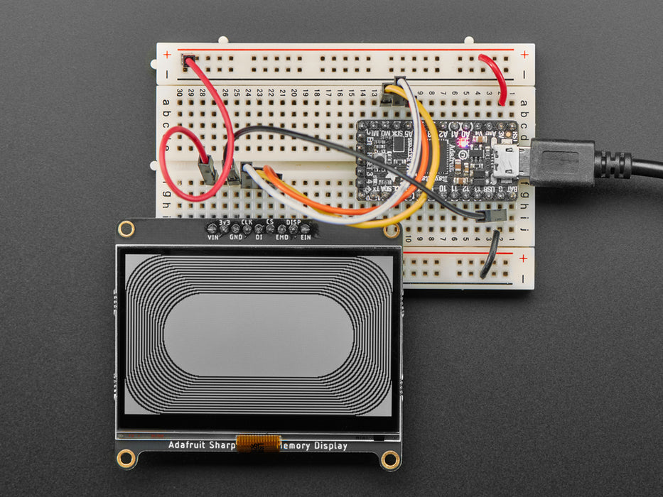 Adafruit SHARP Memory Display Breakout connected to a half-sized breadboard and a microcontroller. The breakout board plays a black and white animation video of black figures playing violins and a keyboard.