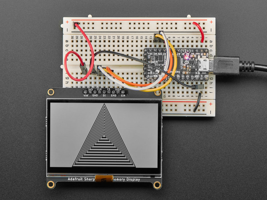 Adafruit SHARP Memory Display Breakout connected to a half-sized breadboard and a microcontroller. The breakout board plays a black and white animation video of black figures playing violins and a keyboard.