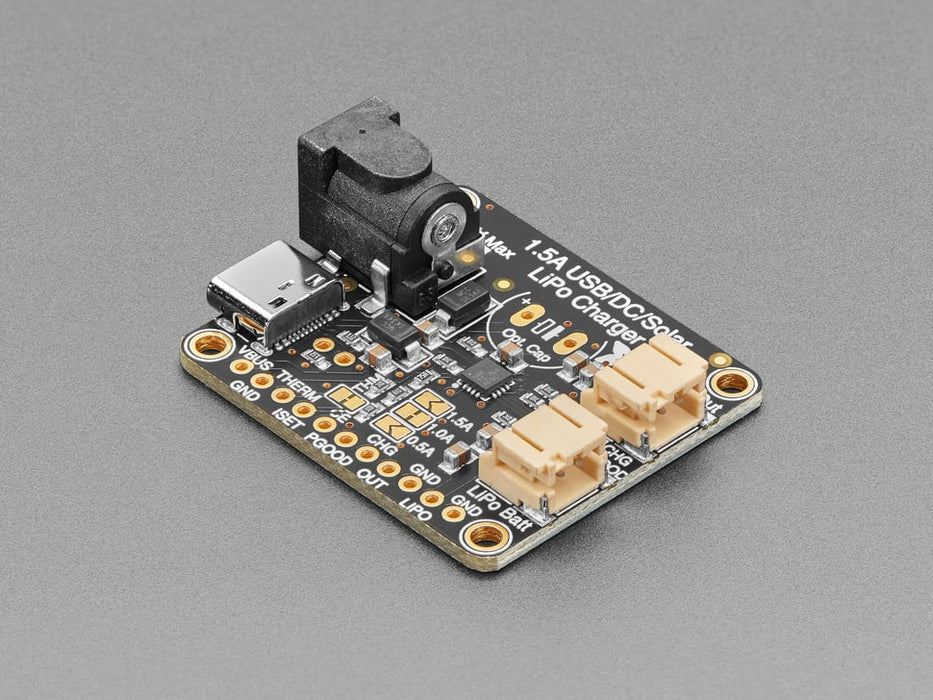 Angled shot of a Adafruit Universal USB / DC / Solar Lithium Ion/Polymer charger connected to a solar panel and 3 AAA batteries. 