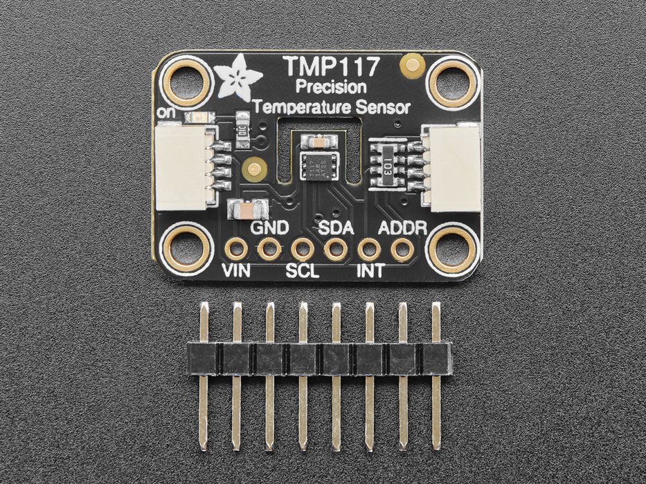 Finger on sensor connected to a Feather via QT cable, with OLED wing showing skin temperature