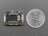 Finger on sensor connected to a Feather via QT cable, with OLED wing showing skin temperature