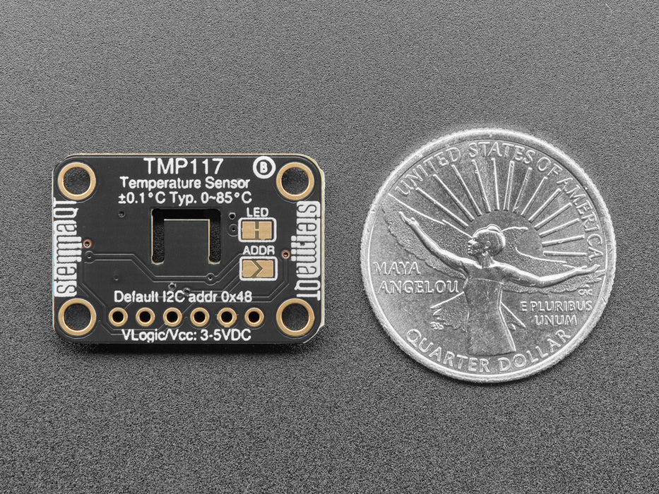 Finger on sensor connected to a Feather via QT cable, with OLED wing showing skin temperature