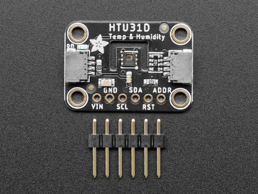 Top view of humidity breakout above an OLED display FeatherWing. The OLED display reads: "HTU31 Demo Temp: 24.19ºC Hum: 37.13%"