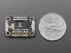 Top view of humidity breakout above an OLED display FeatherWing. The OLED display reads: "HTU31 Demo Temp: 24.19ºC Hum: 37.13%"