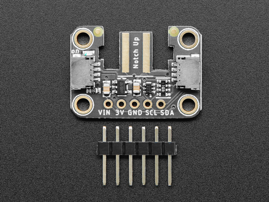 Hand holding a Wiichuck controller pressing buttons. The controller is connected to the breakout wired to a Feather with OLED showing the streaming controller data