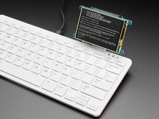 Video of a person typing code on a Pi 400 keyboard. A PiTFT display is connected to the keyboard, and a heart wallpaper appears on the TFT.