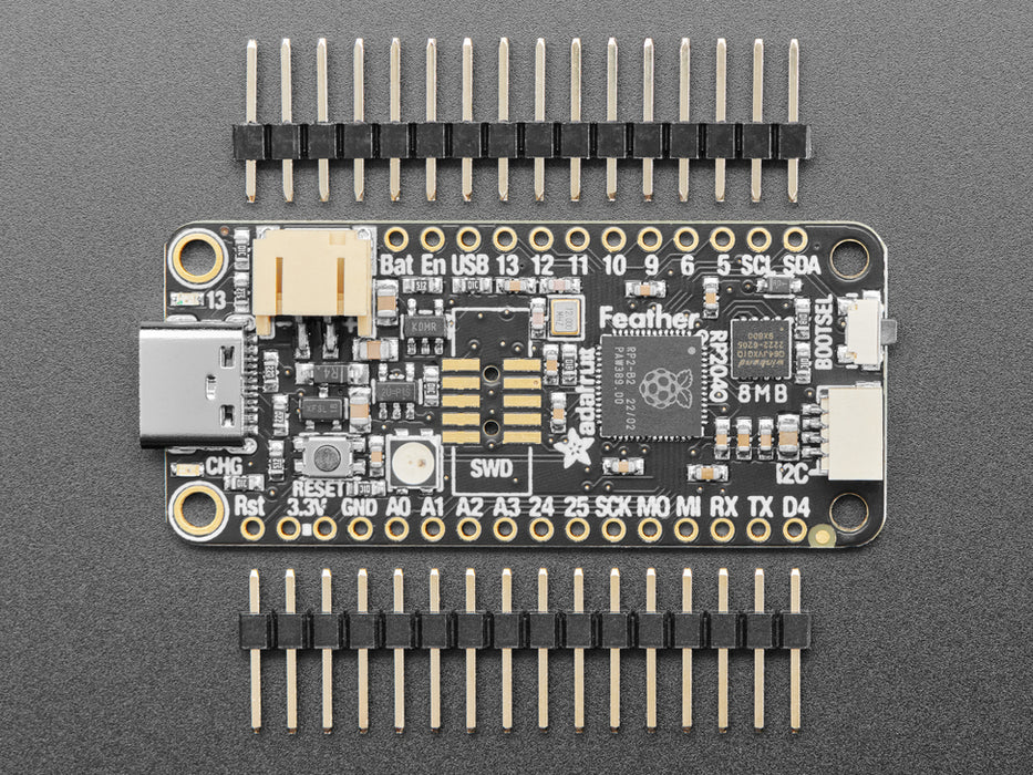 Angled shot of black rectangular microcontroller "Feather RP2040"