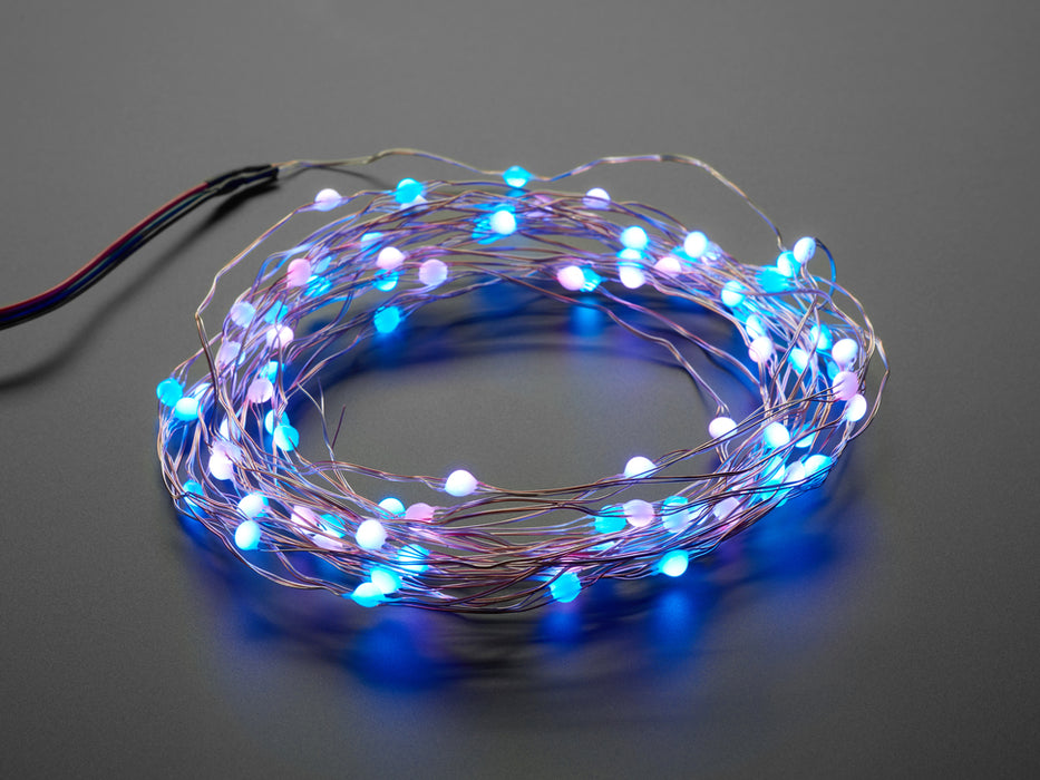 Angled shot of a Fixed Address NeoPixel LED Fairy Lights - 100 Wired LEDs changing various colors. 