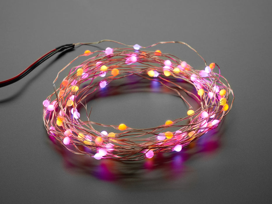 Angled shot of a Fixed Address NeoPixel LED Fairy Lights - 100 Wired LEDs changing various colors. 