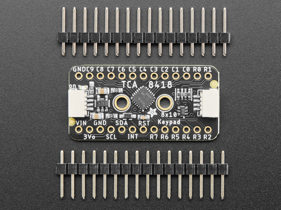 Video of an iridescent manicured hand tapping numbers on a flexible keypad matrix connected to a microcontroller on a full-size breadboard. The key inputs display on an OLED breakout.