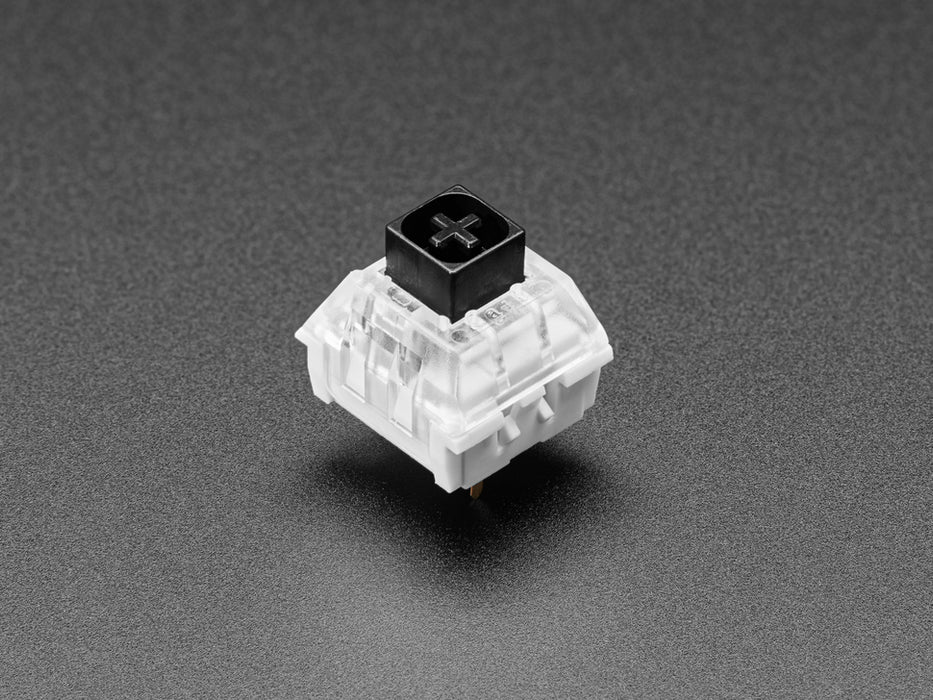 Angled shot of ten black Kailh key switches.