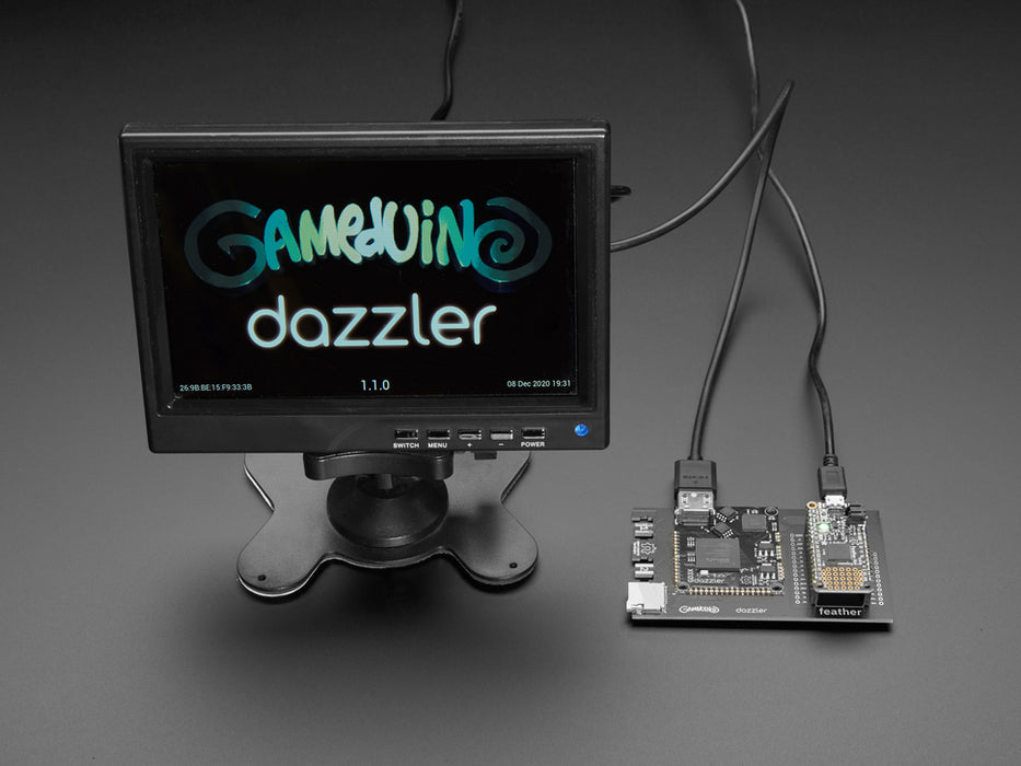 A small monitor and a Gameduino Dazzler PCB with a Feather M4 Express. The monitor displays a swirling kaleidoscopic animation with CircuitPython and Blinka, a friendly coding python.