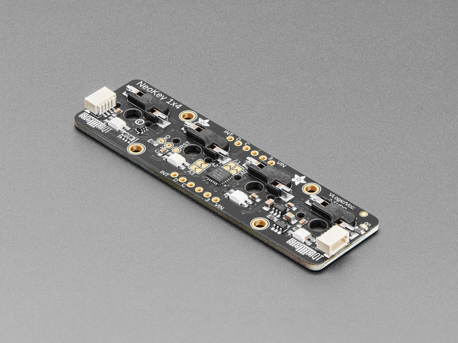 Top view video of a fully assembled NeoKey 1x4 QT I2C with switches and smoke gray keycaps powered by a QT Py on a breadboard. A hand reaches down to press the keys, which emit rainbow colors. 