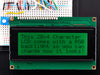 LCD wired on breadboard with backlight changing color with text displayed: "This 20x4 Character LCD comes with an RGB backlight so you can change how it looks".