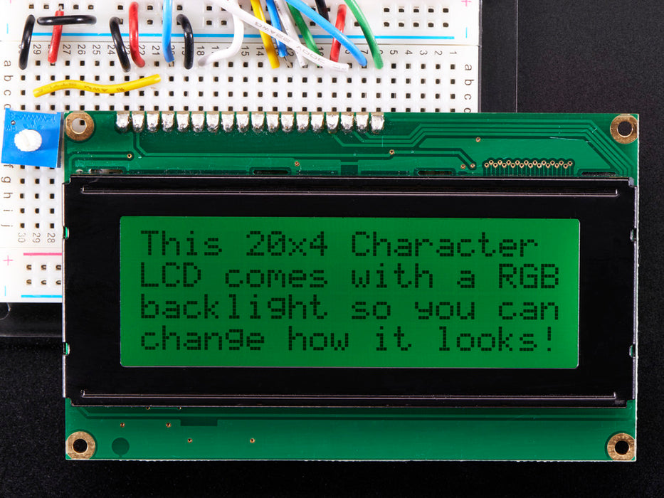 LCD wired on breadboard with backlight changing color with text displayed: "This 20x4 Character LCD comes with an RGB backlight so you can change how it looks".