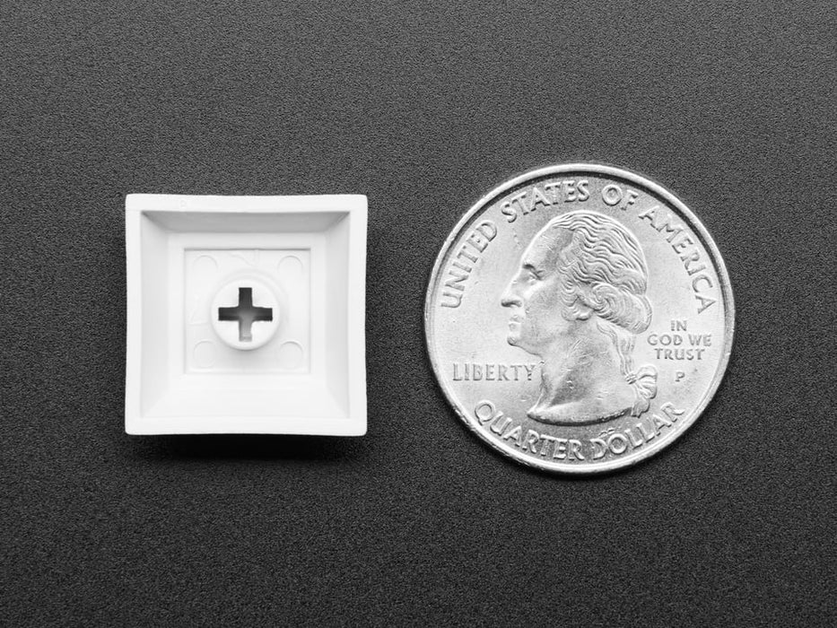 Angled shot of 10 gray plastic keycaps.