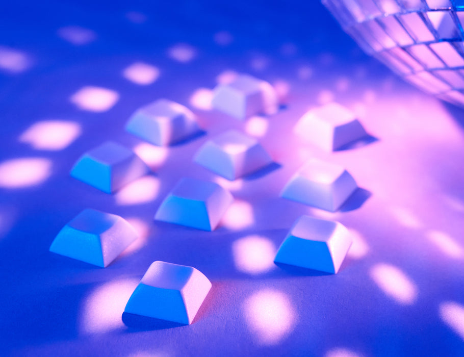 Angled shot of 10 gray plastic keycaps.