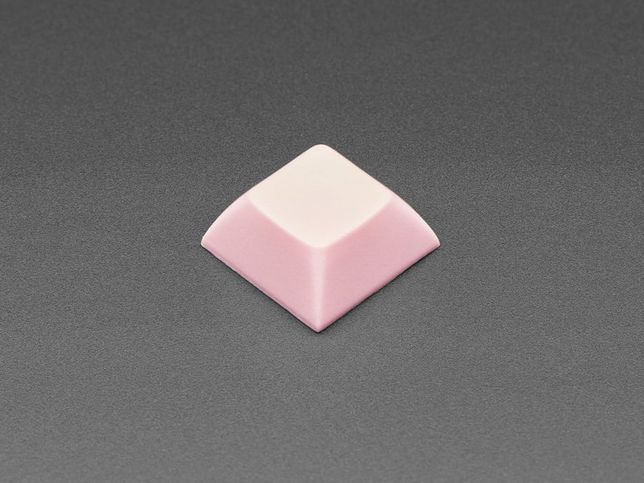 Angled shot of 10 pink plastic keycaps.