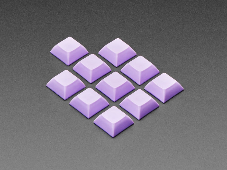 Angled shot of 10 lavender plastic keycaps.