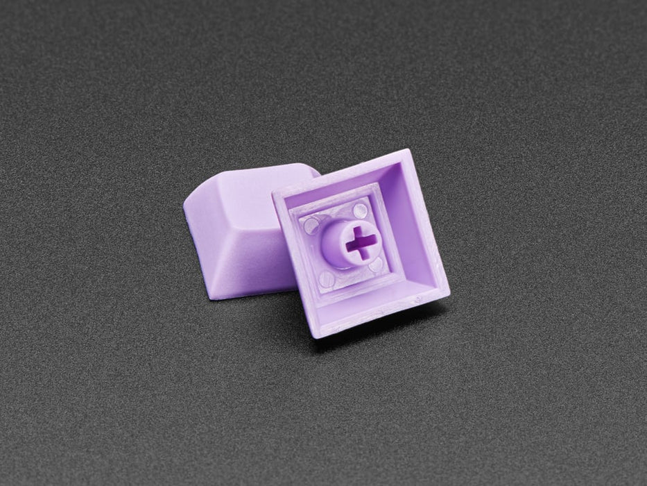 Angled shot of 10 lavender plastic keycaps.