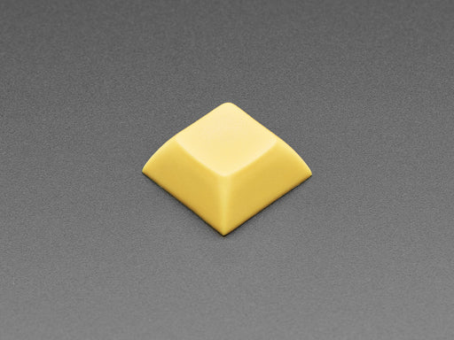 Angled shot of 10 dark yellow plastic keycaps.