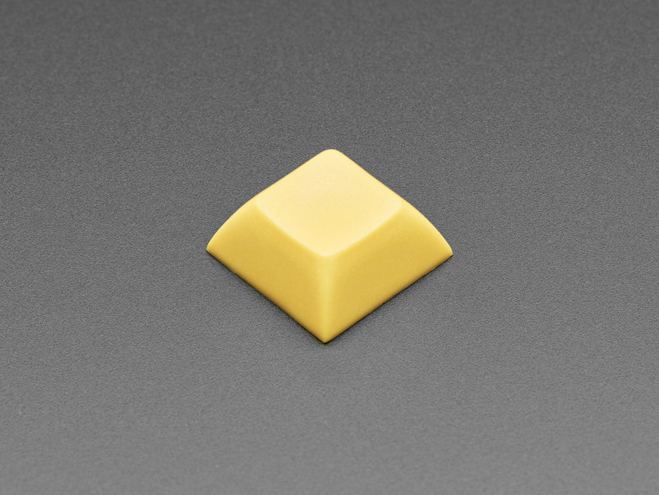 Angled shot of 10 dark yellow plastic keycaps.