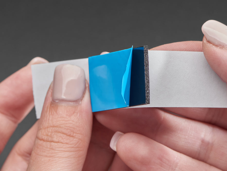 Angled shot of single blue rectangular foam tape.