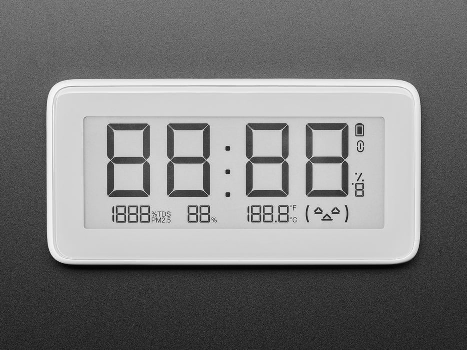 Shot of a work station shelf populated with electronic tools and a clear glass head filled with glowing LED strips. The eInk clock sits below reading the time, temperature, and humidity.