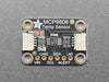 Top view of temperature sensor breakout above an OLED display FeatherWing. The OLED display reads "MCP9808 Temp: 24.19��C"