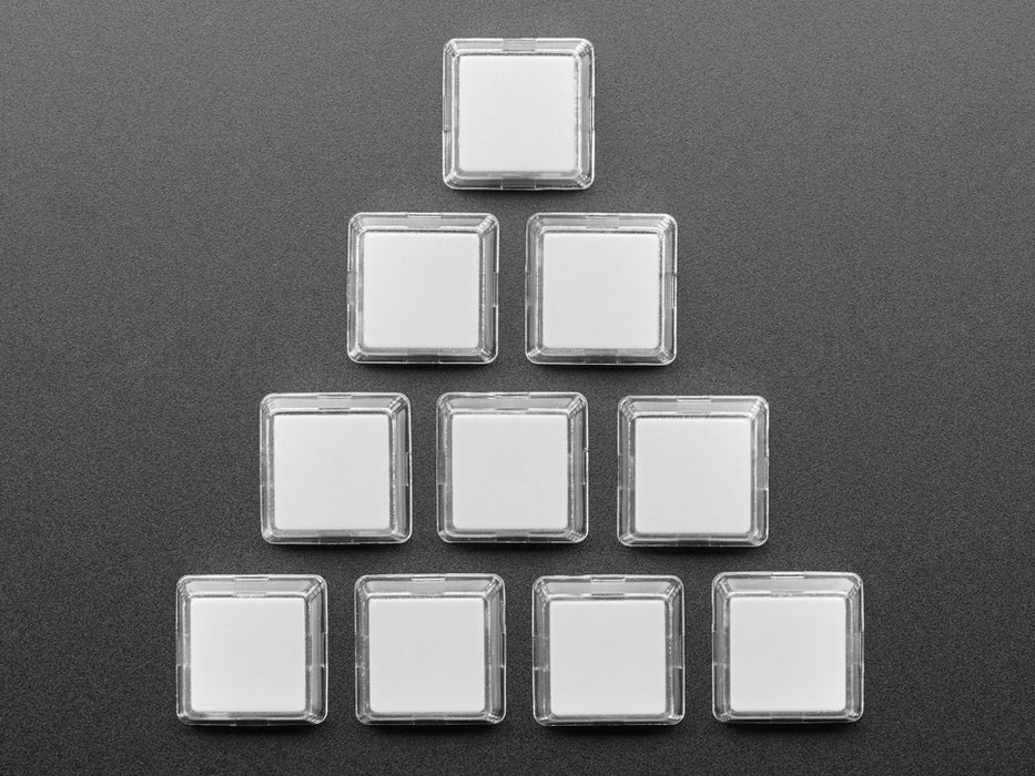 Angled shot of ten white plastic keycaps.