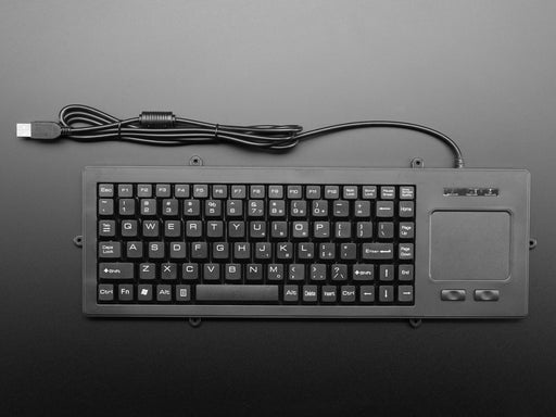 Top view of a white woman's hands typing on full-size keyboard with trackpad.