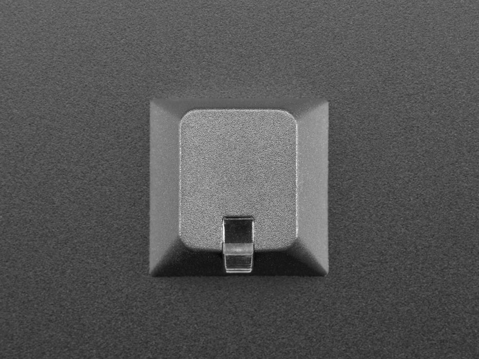 Angled shot of single black 1U R4 lamp keycap.