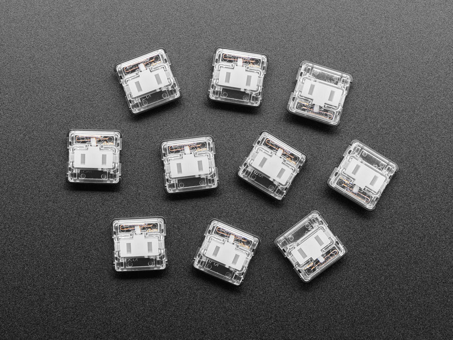 Angled shot of ten white Kailh Choc V1 keycaps.